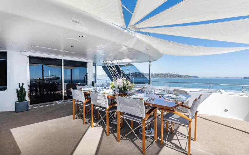 a dining table on a patio aboard FIGARO Yacht for Sale