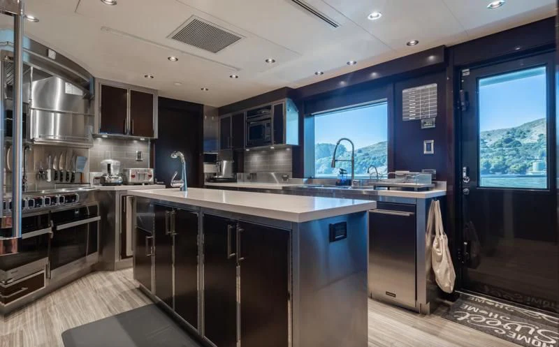 a kitchen with a large island aboard FIGARO Yacht for Sale