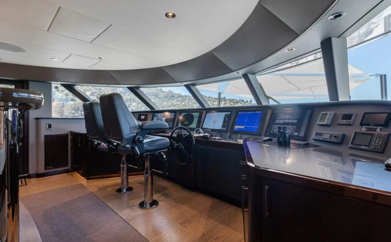 a room with a desk and chairs aboard FIGARO Yacht for Sale