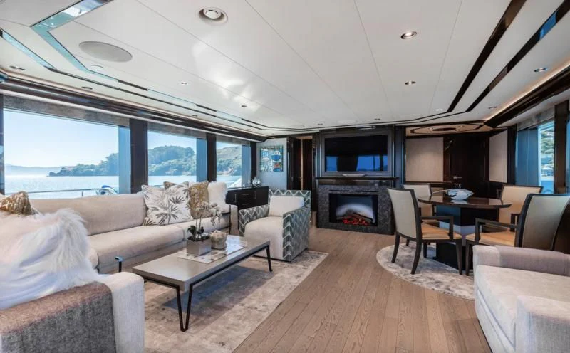 a living room with a fireplace aboard FIGARO Yacht for Sale