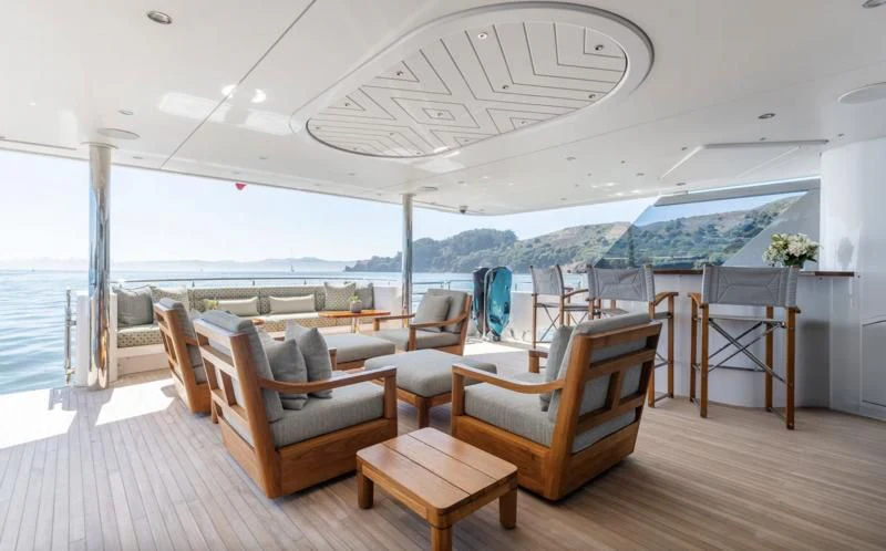 a room with a table chairs and a large window aboard FIGARO Yacht for Sale