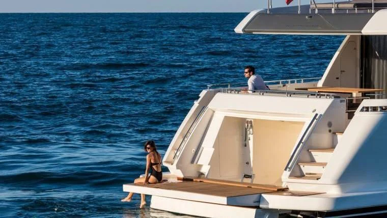 a couple people sitting on a boat aboard TO INDIA Yacht for Sale