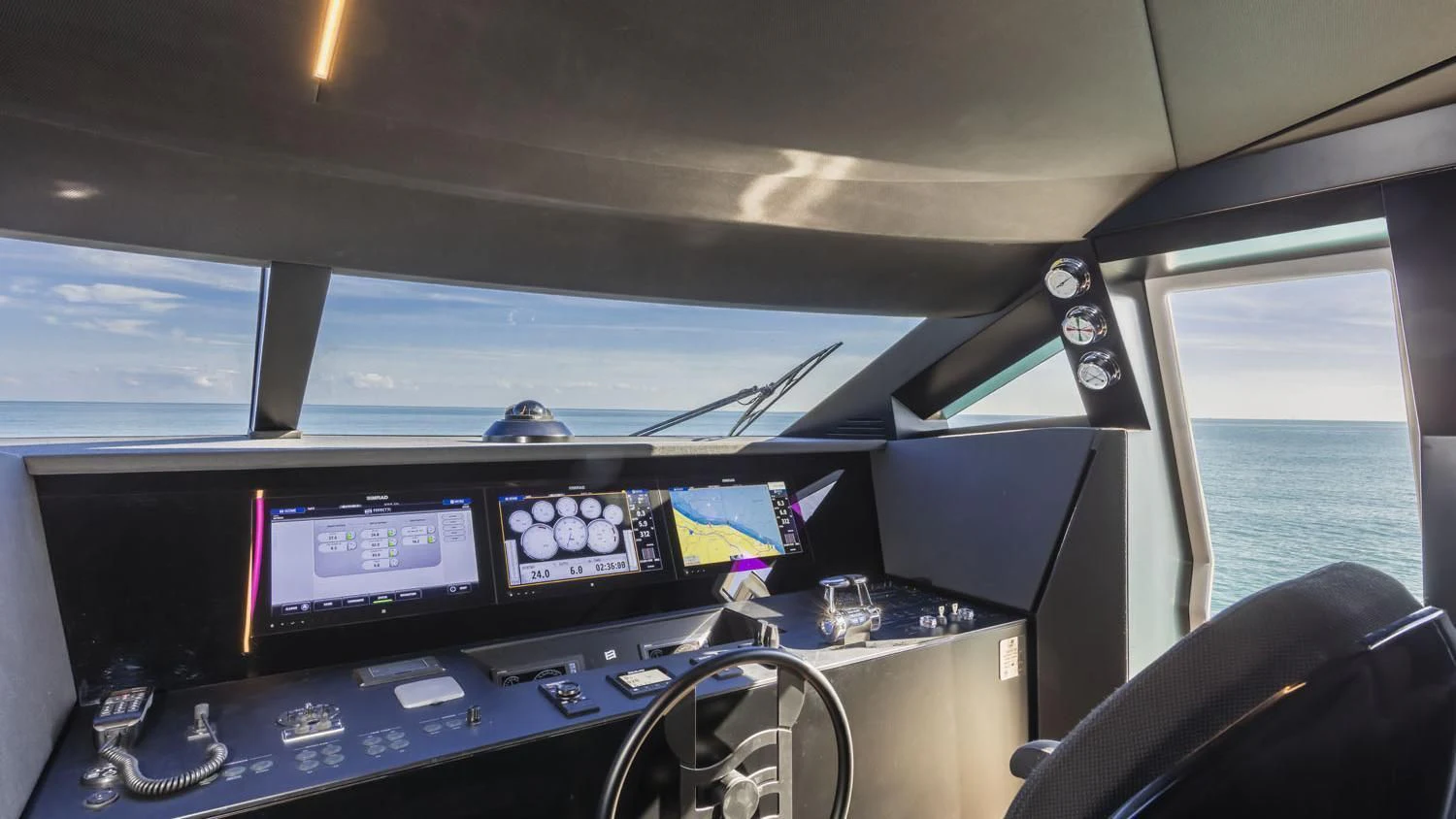 inside of a vehicle with monitors and a boat in the water aboard TO INDIA Yacht for Sale