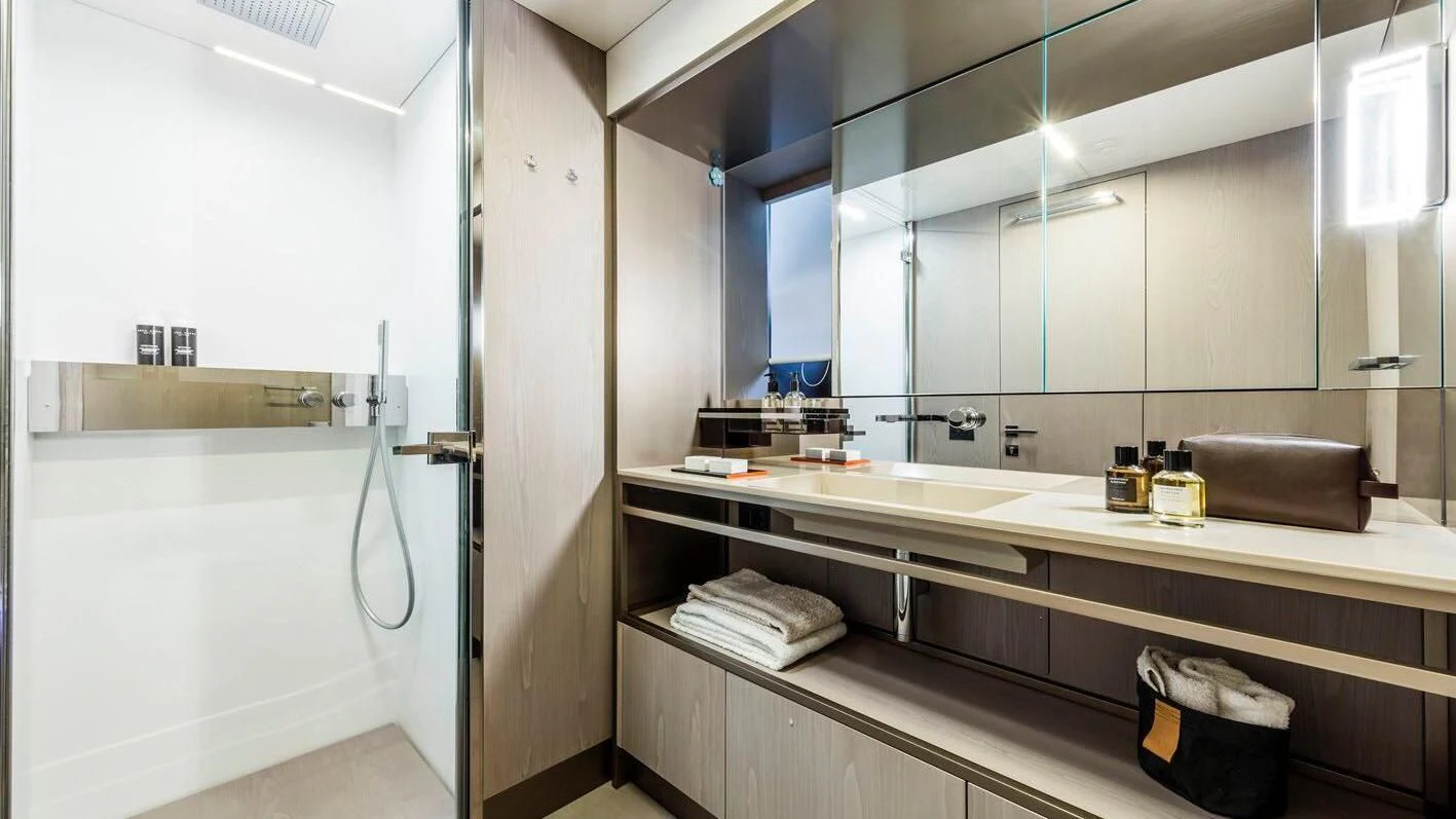 a bathroom with a large mirror aboard TO INDIA Yacht for Sale