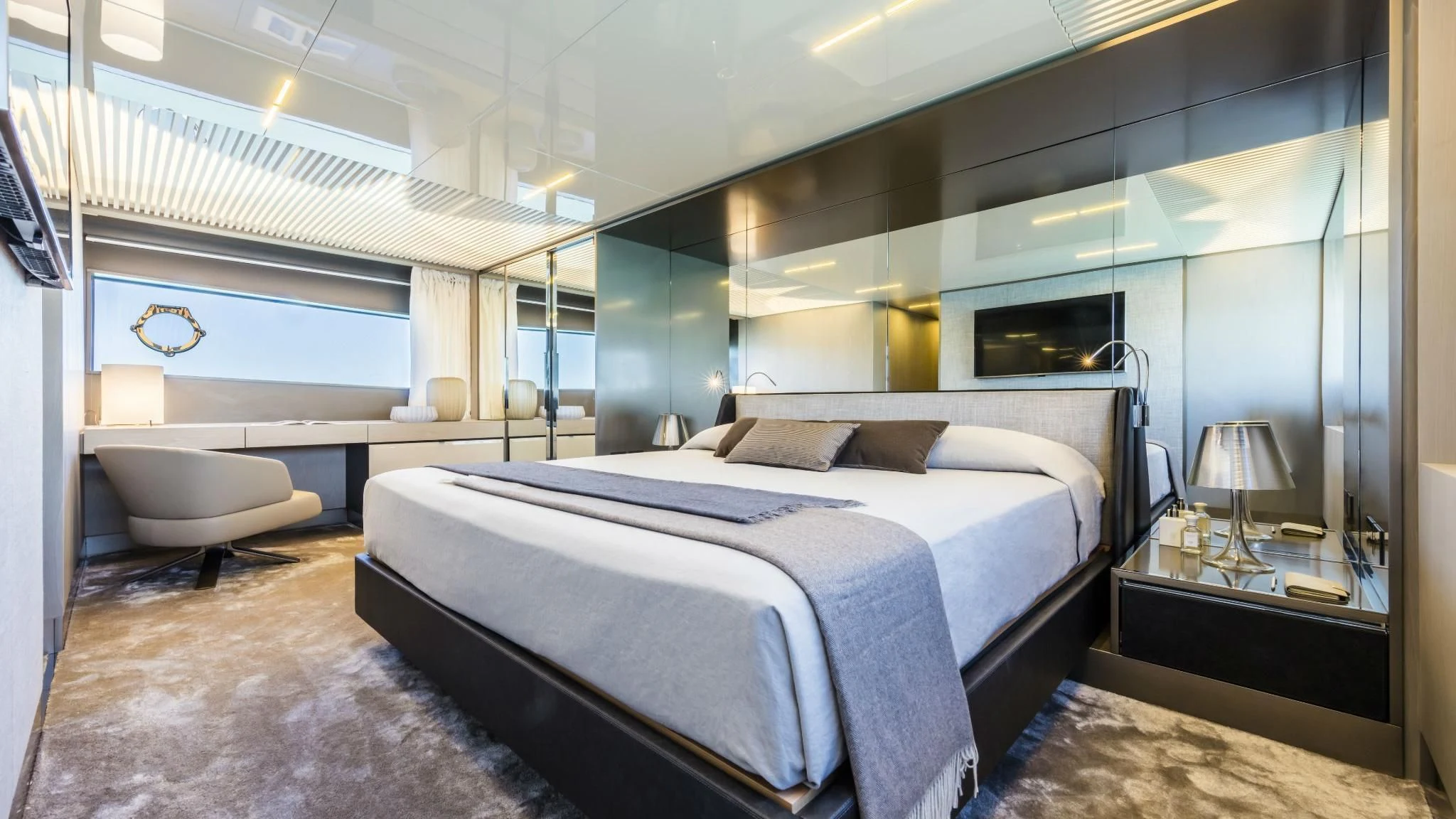 a bedroom with a bed and a chair aboard TO INDIA Yacht for Sale