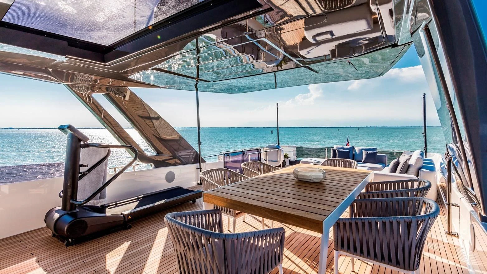 a table and chairs on a deck aboard TO INDIA Yacht for Sale