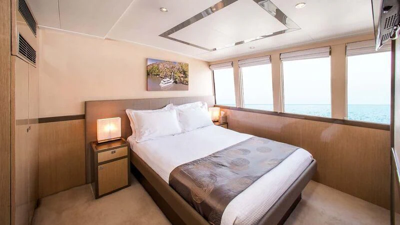 a bedroom with a bed and a window aboard OCEAN DREAM Yacht for Sale