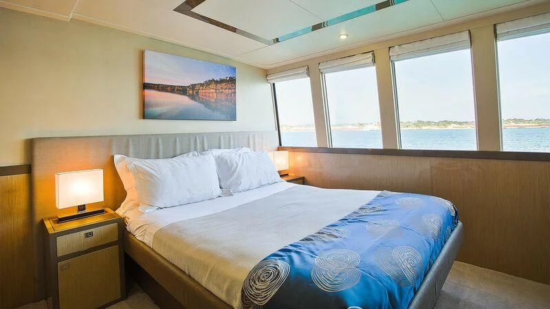 a bedroom with a bed and a window aboard OCEAN DREAM Yacht for Sale