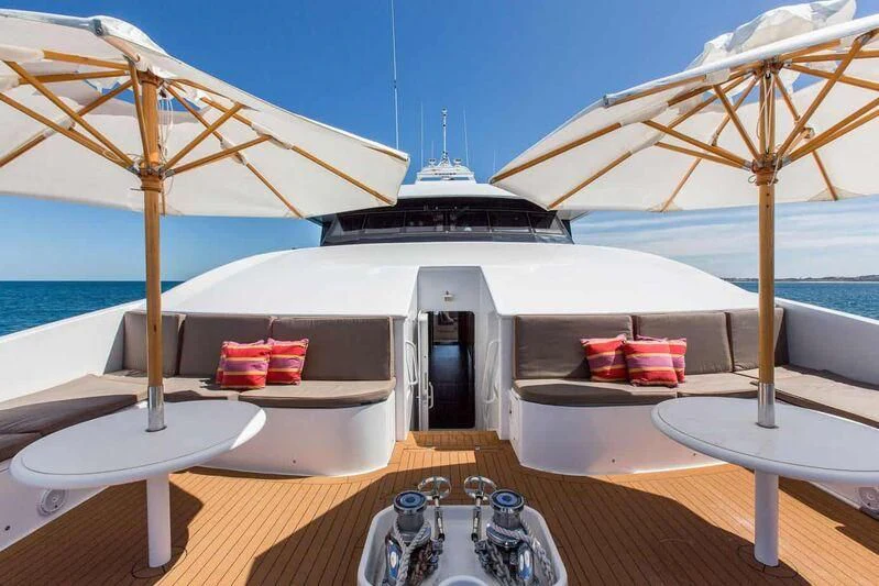 a table with chairs and umbrellas on it aboard OCEAN DREAM Yacht for Sale