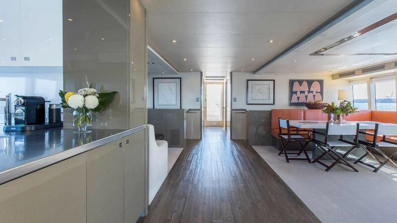 a kitchen with a table and chairs aboard OCEAN DREAM Yacht for Sale