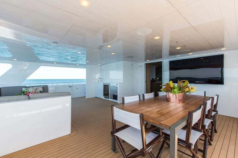 a large room with a table and chairs aboard OCEAN DREAM Yacht for Sale
