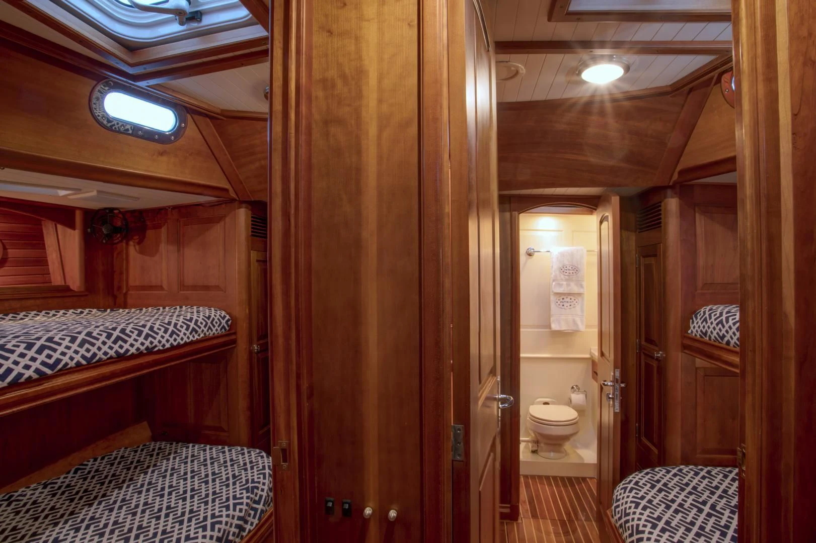 a bathroom with a wood door aboard PATRIOT Yacht for Sale