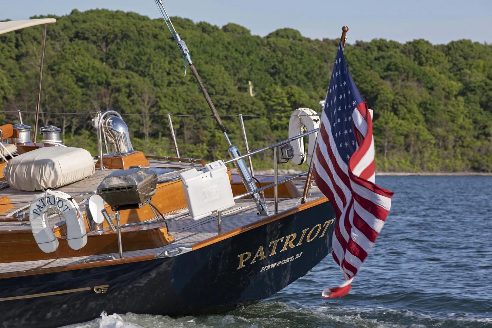 a boat with a sail on the water aboard PATRIOT Yacht for Sale