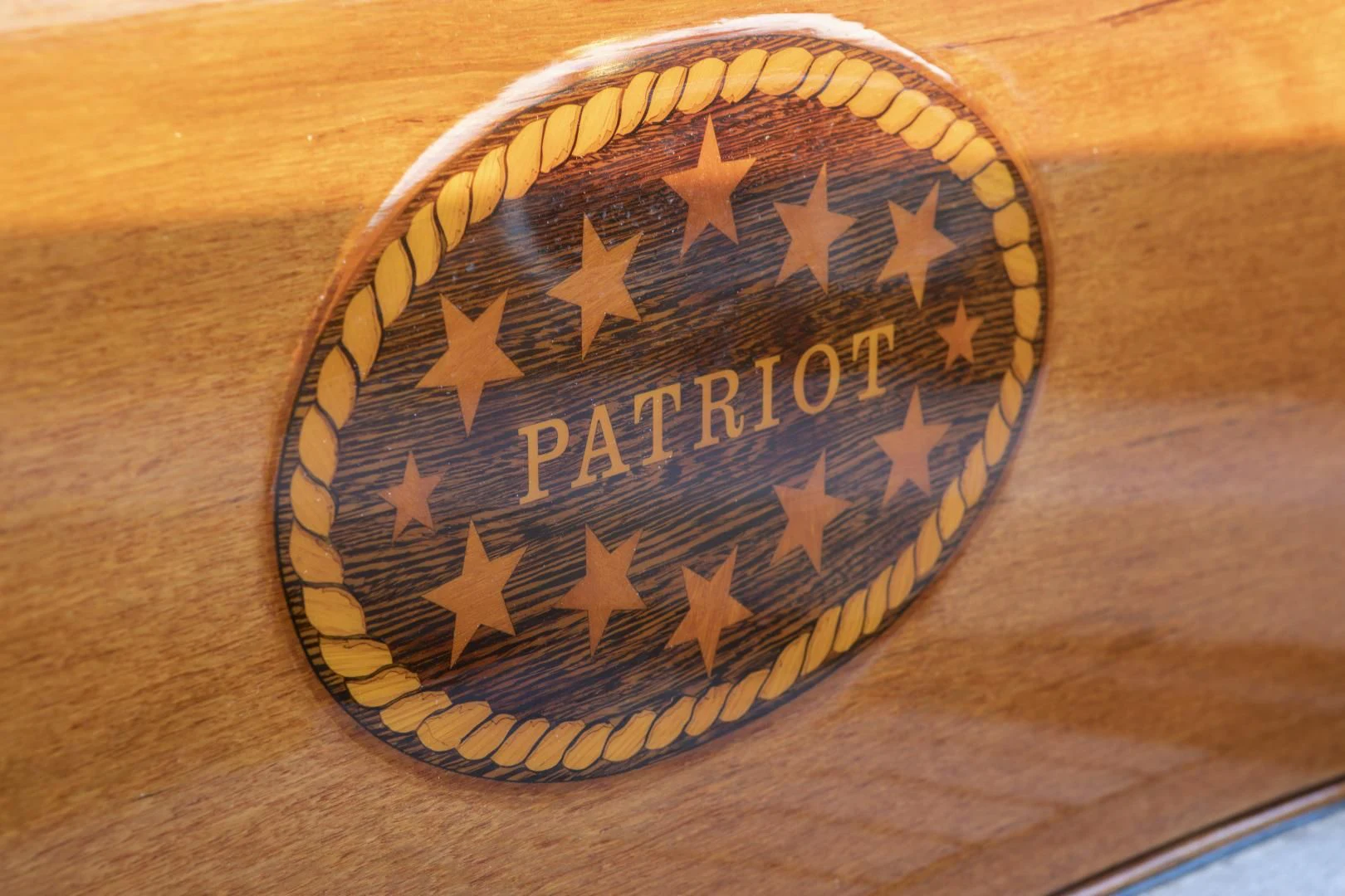 a gold and blue badge aboard PATRIOT Yacht for Sale