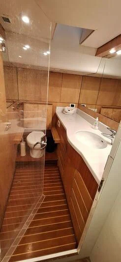 a bathroom with a wood floor aboard ALMUNDARVI Yacht for Sale