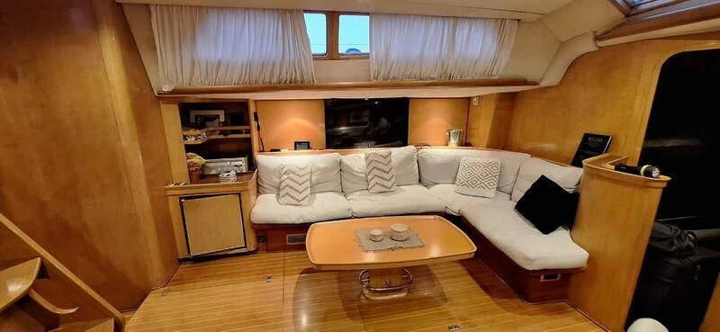 a living room with a couch and a coffee table aboard ALMUNDARVI Yacht for Sale