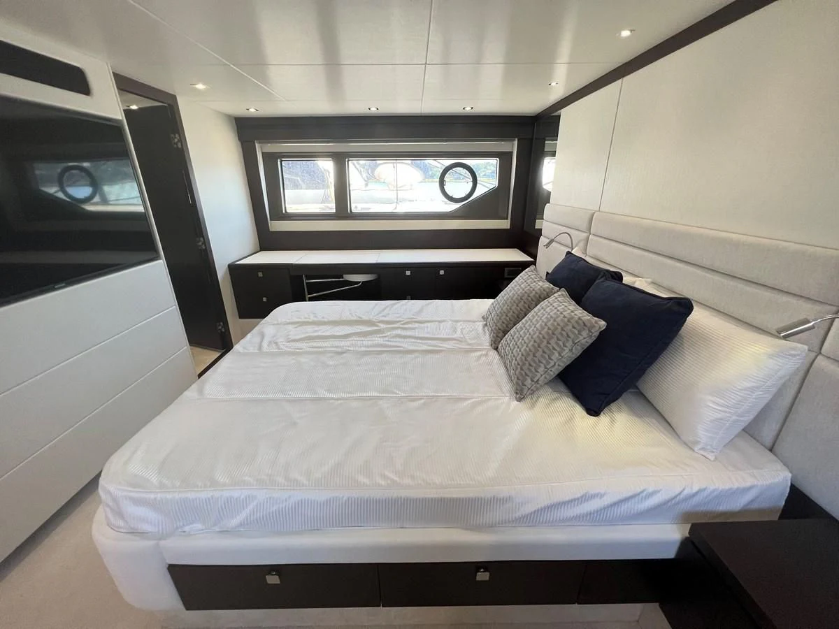 a bed with a white sheet and pillows on it aboard 66 MANHATTAN Yacht for Sale
