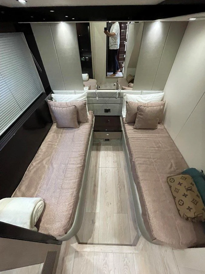 a room with a bed and a mirror aboard 66 MANHATTAN Yacht for Sale