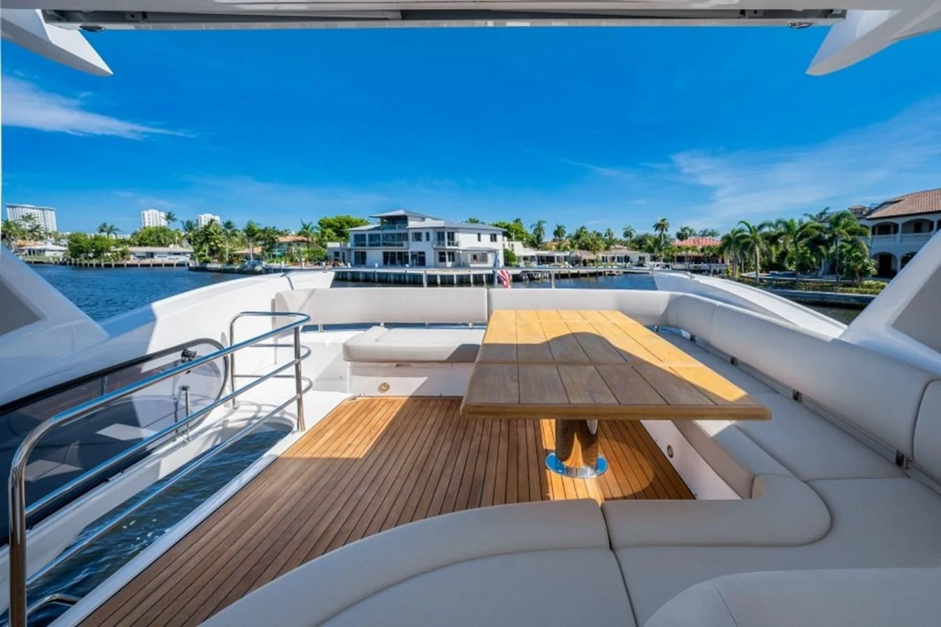 a deck with a pool and buildings in the background aboard 66 MANHATTAN Yacht for Sale