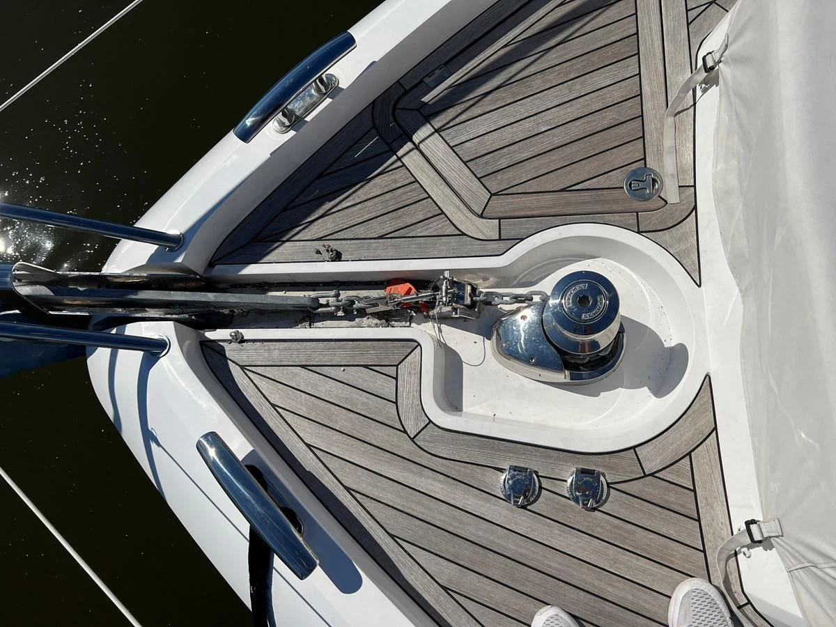a white boat with a blue and silver boat in the water aboard 66 MANHATTAN Yacht for Sale