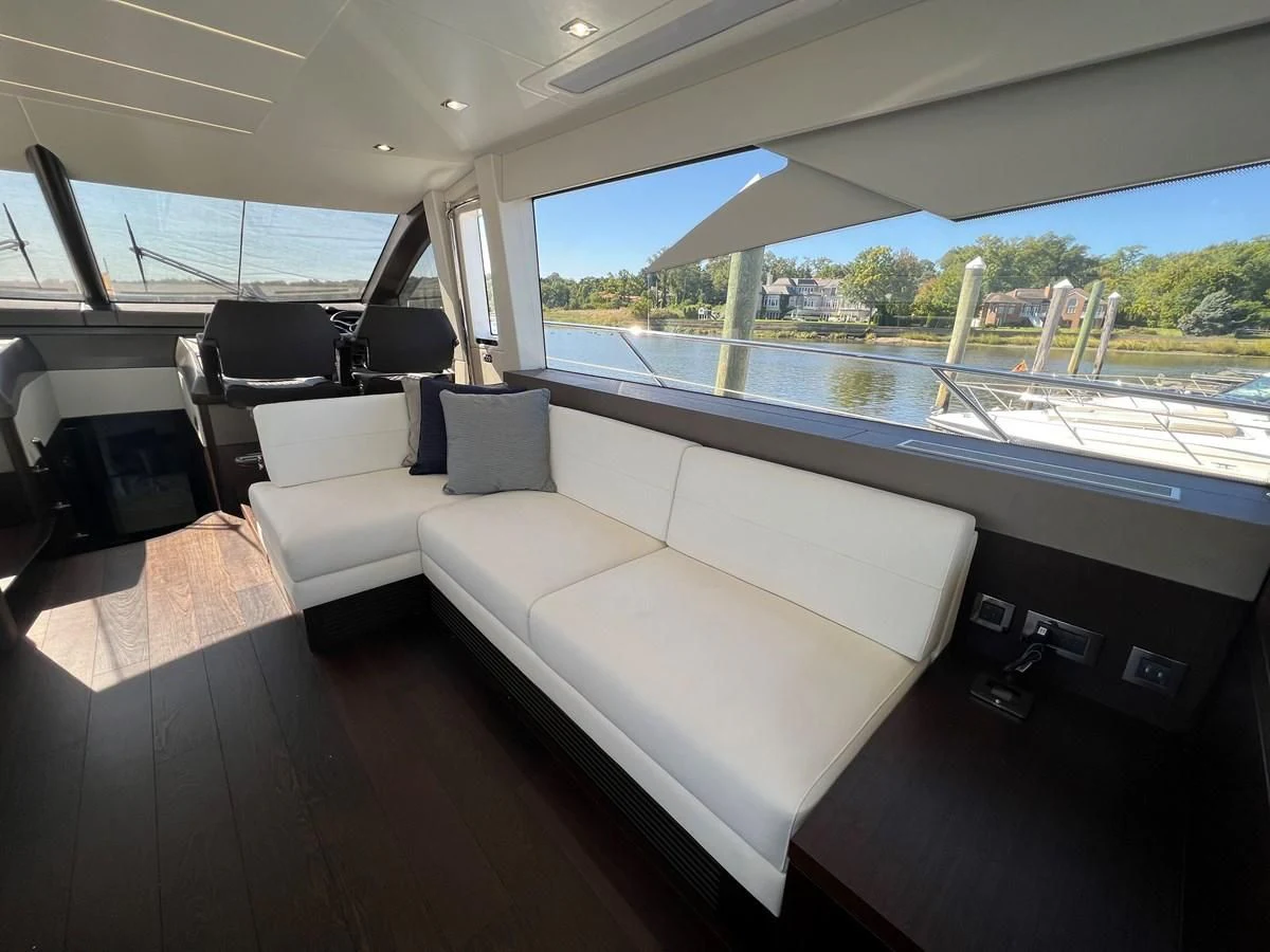 a room with a couch and a large window aboard 66 MANHATTAN Yacht for Sale