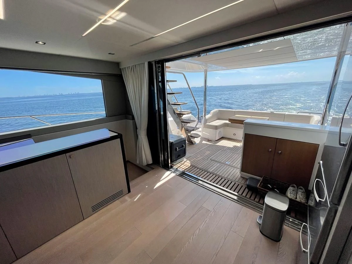 a room with a large window and a deck overlooking the ocean aboard 66 MANHATTAN Yacht for Sale