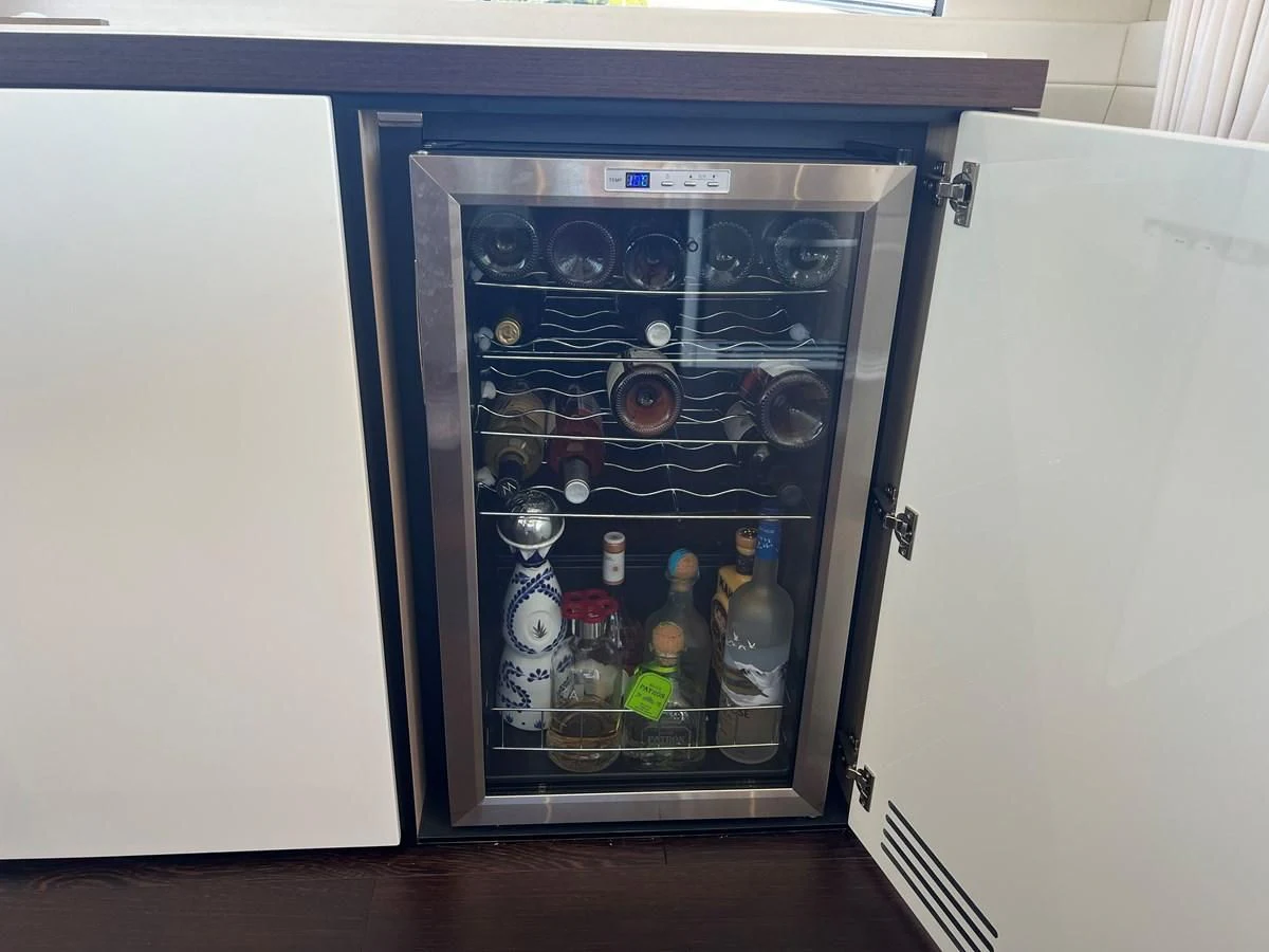 a mini fridge with drinks and bottles aboard 66 MANHATTAN Yacht for Sale
