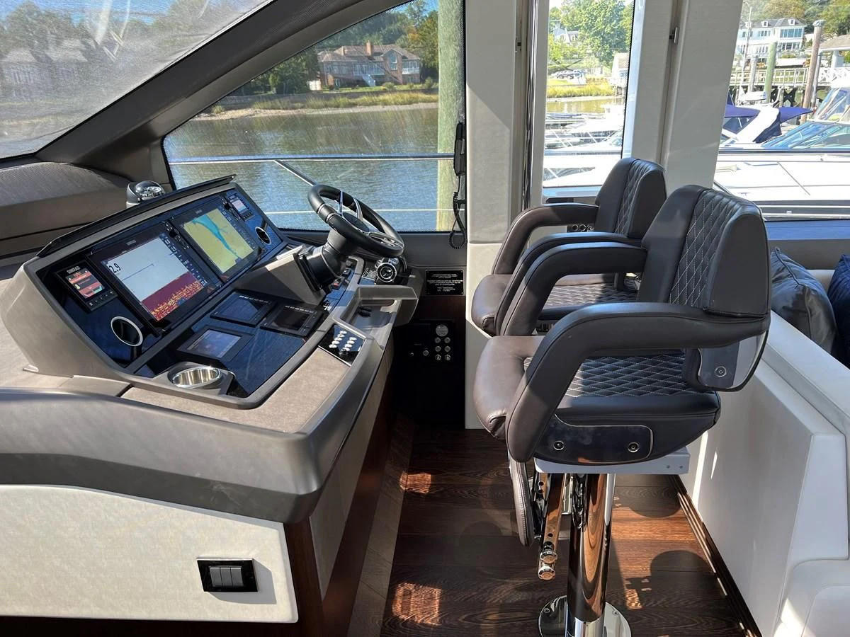 a car with a computer and a seat aboard 66 MANHATTAN Yacht for Sale