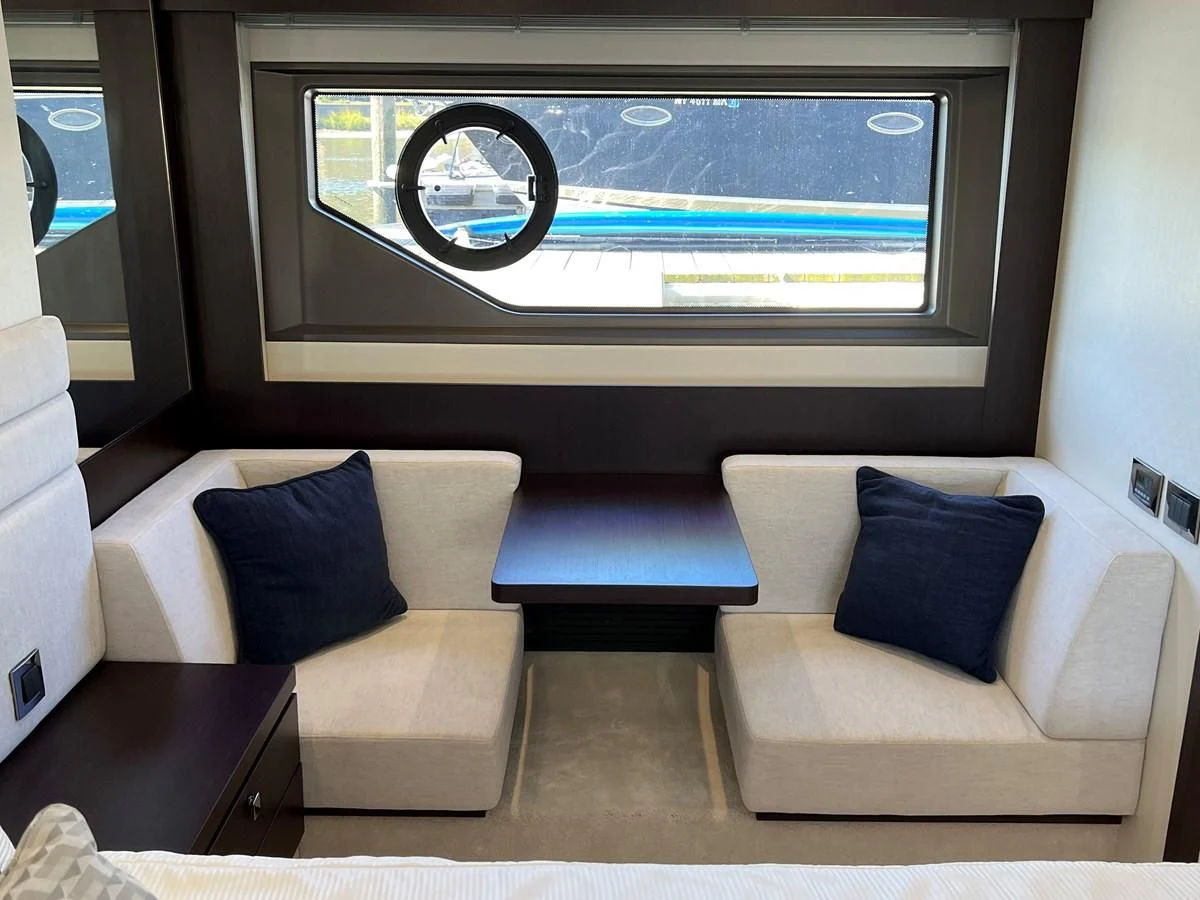 a room with a couch and a tv on the wall aboard 66 MANHATTAN Yacht for Sale