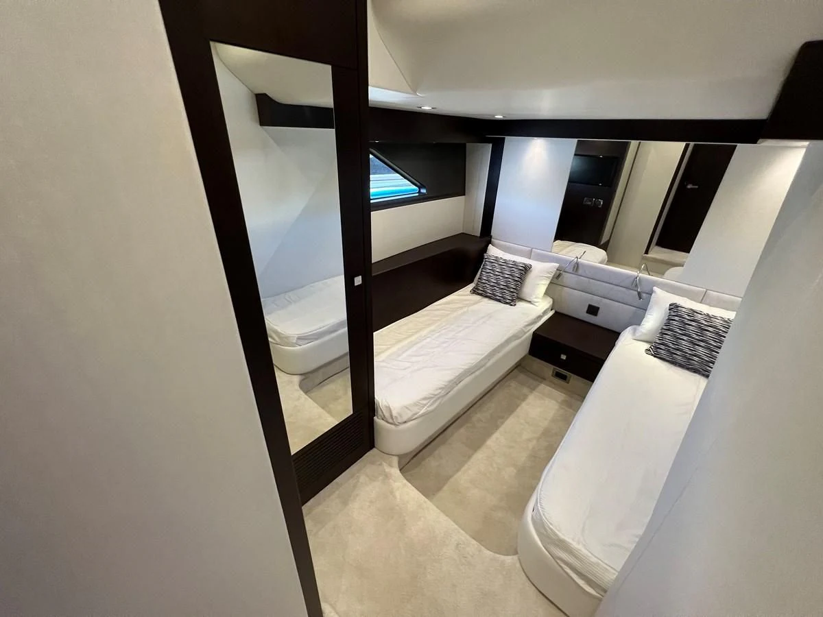 a room with a bed and a window aboard 66 MANHATTAN Yacht for Sale