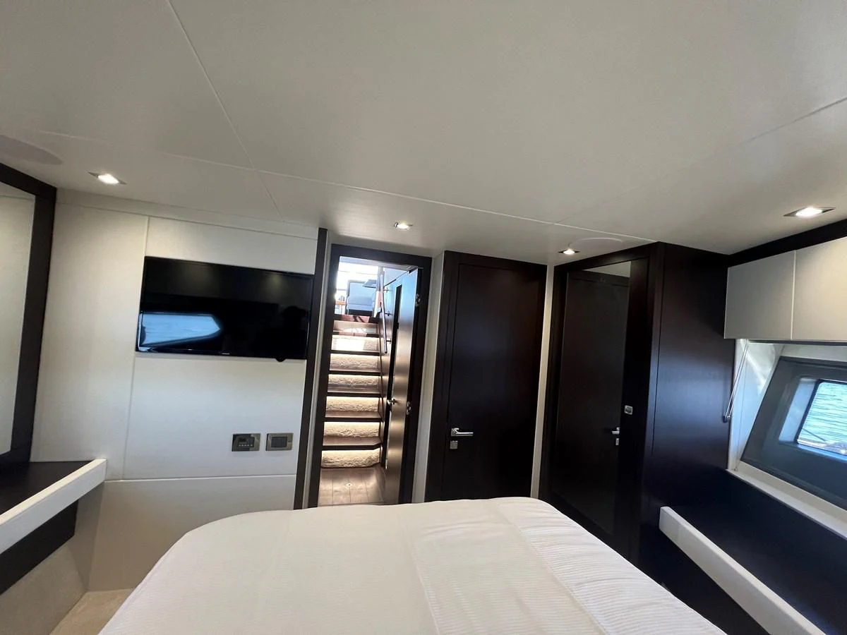 a room with a bed and a tv aboard 66 MANHATTAN Yacht for Sale