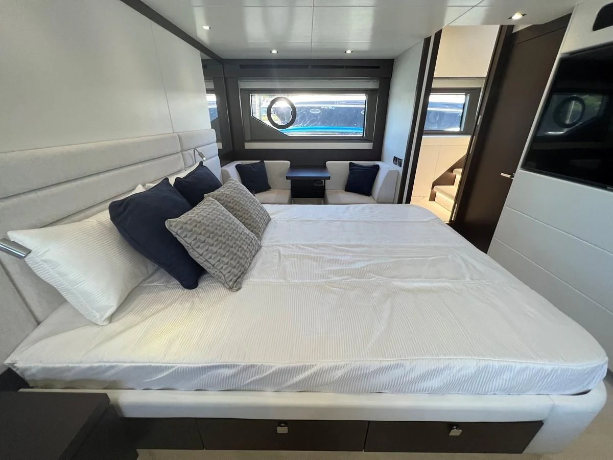 a bed with a white sheet and pillows on it aboard 66 MANHATTAN Yacht for Sale