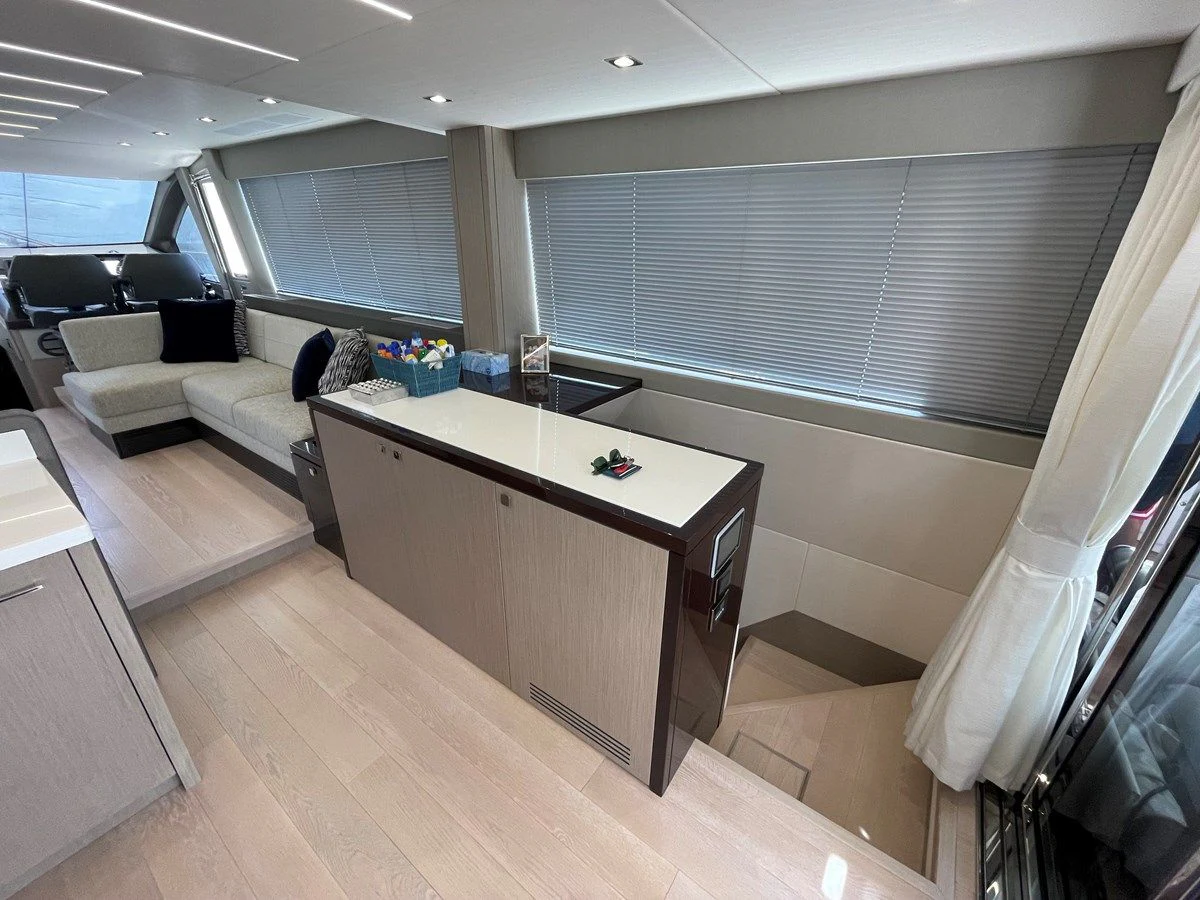 a room with a table and couches aboard 66 MANHATTAN Yacht for Sale