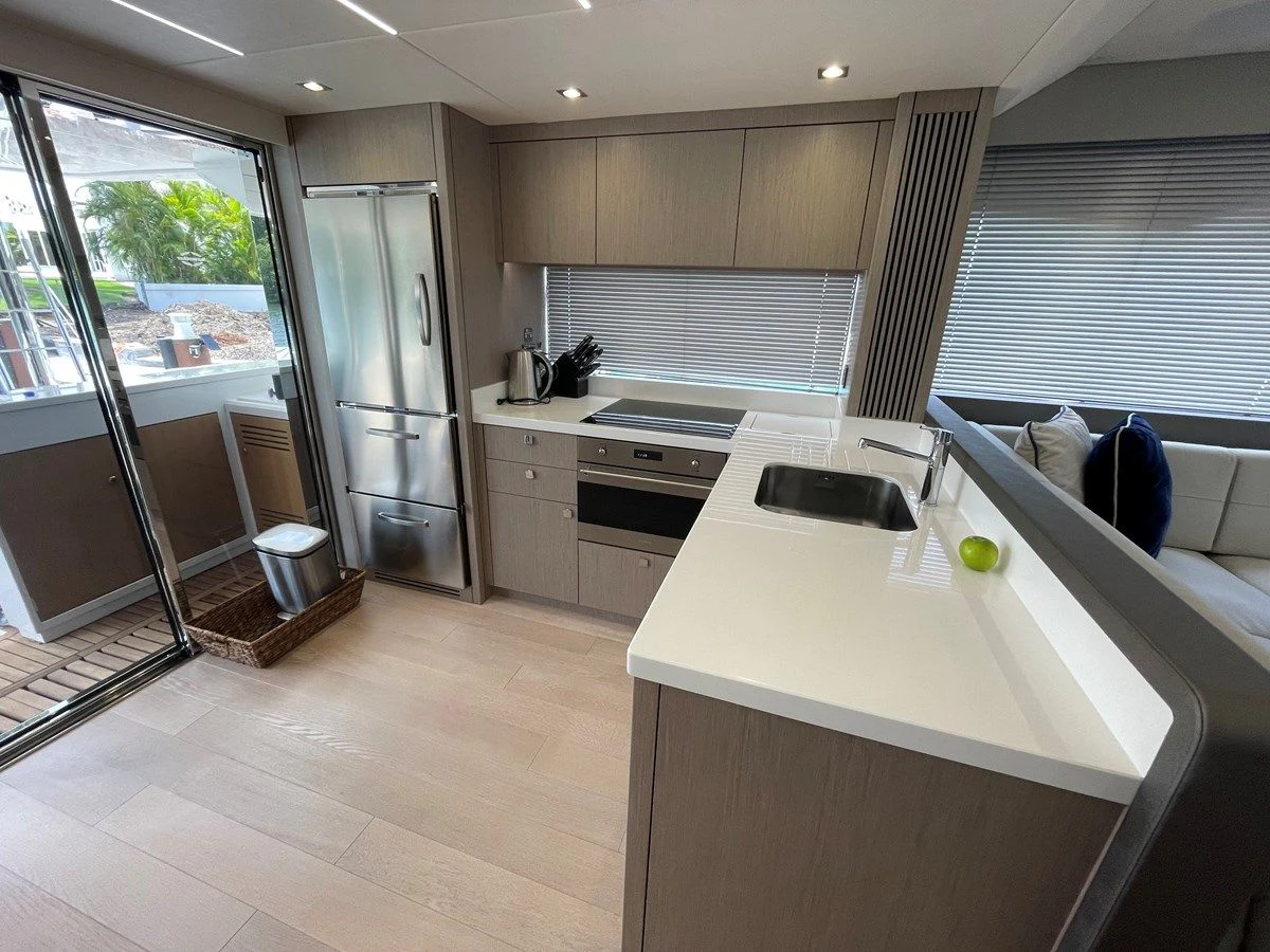 a kitchen with a sink and a refrigerator aboard 66 MANHATTAN Yacht for Sale