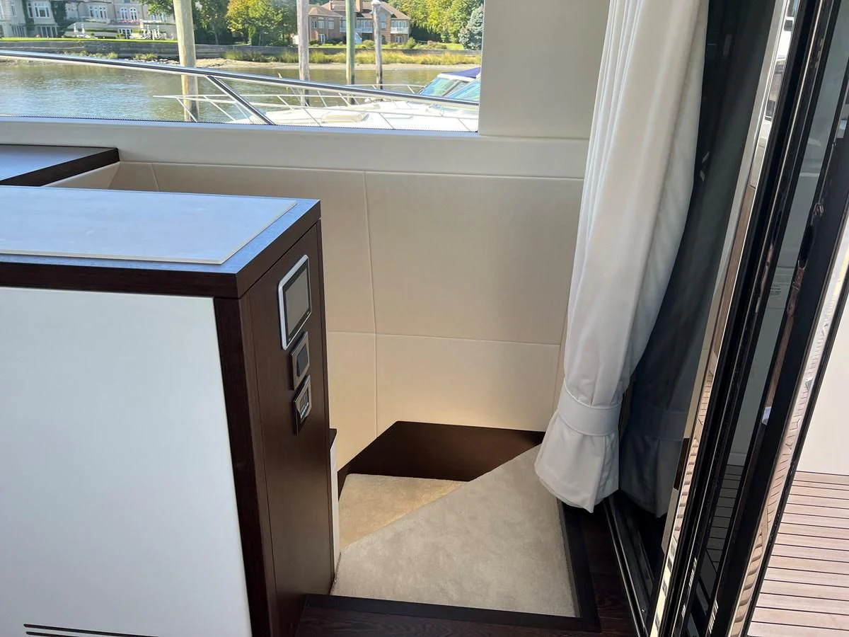 a room with a window and a table with a rug on it aboard 66 MANHATTAN Yacht for Sale