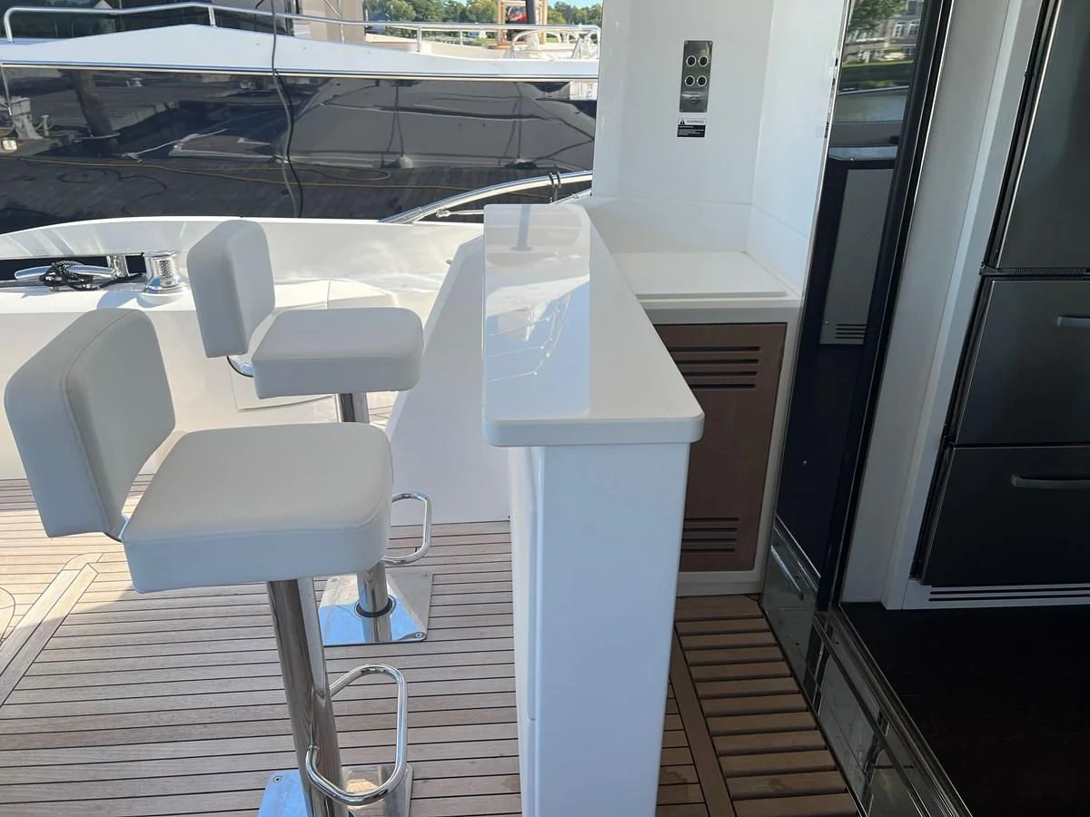 a white table and chairs in a room with a window aboard 66 MANHATTAN Yacht for Sale