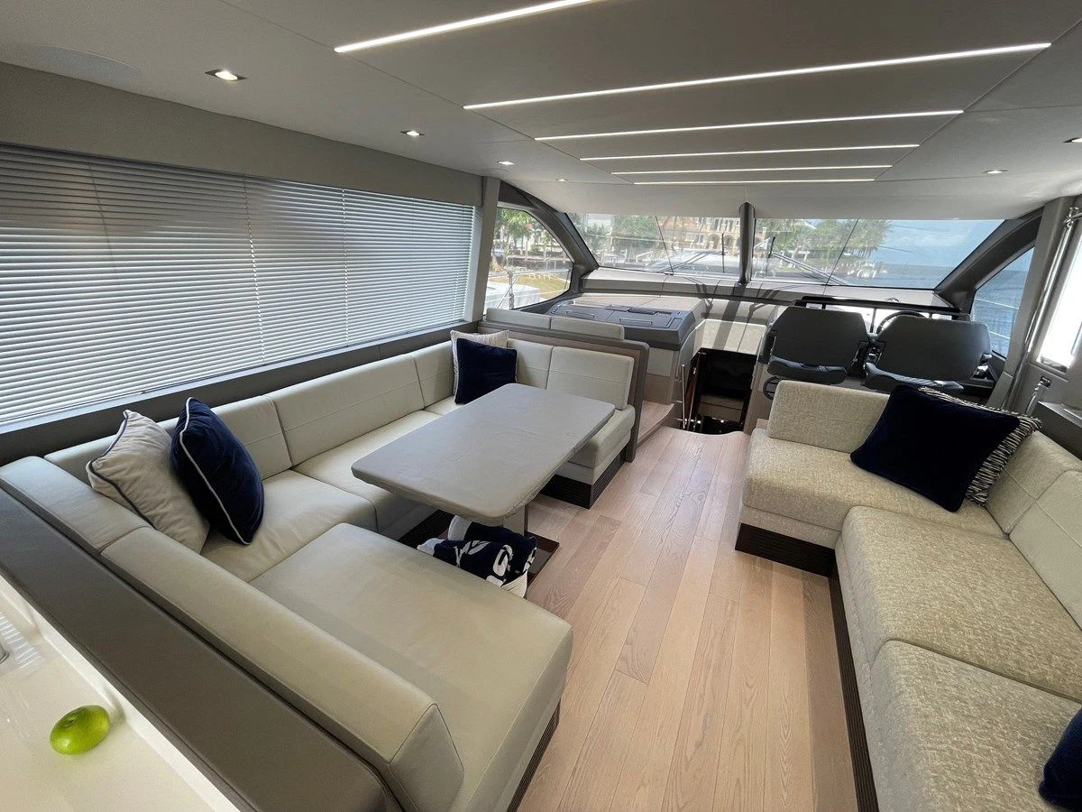 a room with a couch and a table and chairs aboard 66 MANHATTAN Yacht for Sale