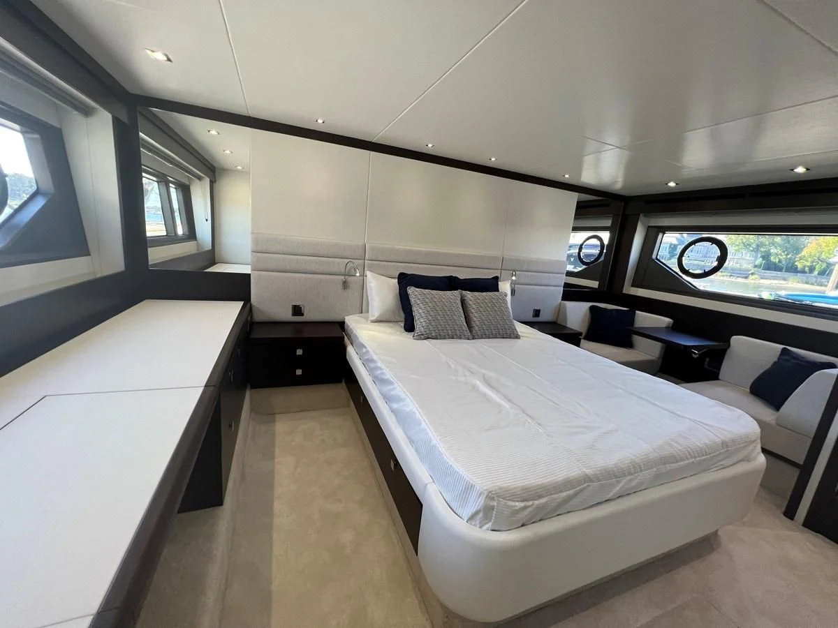 a room with beds and a window aboard 66 MANHATTAN Yacht for Sale