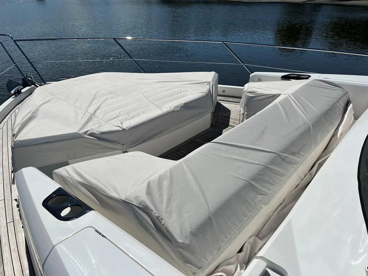 a white car with a white cover aboard 66 MANHATTAN Yacht for Sale