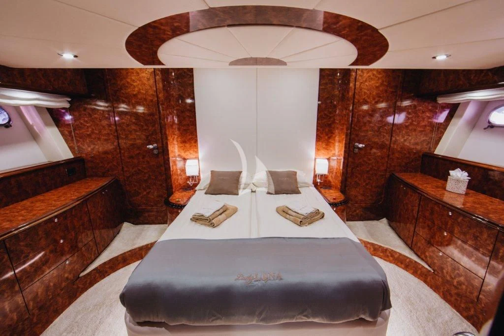 a room with a bed and a desk aboard LADY LONA Yacht for Sale