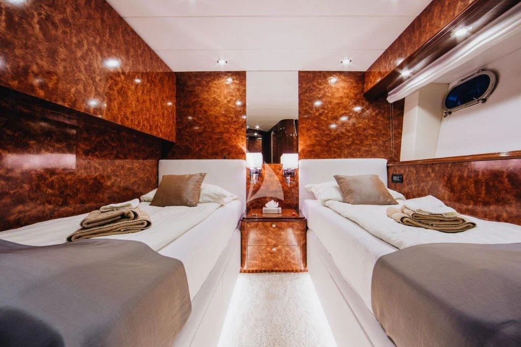 a room with a bed and a table aboard LADY LONA Yacht for Sale