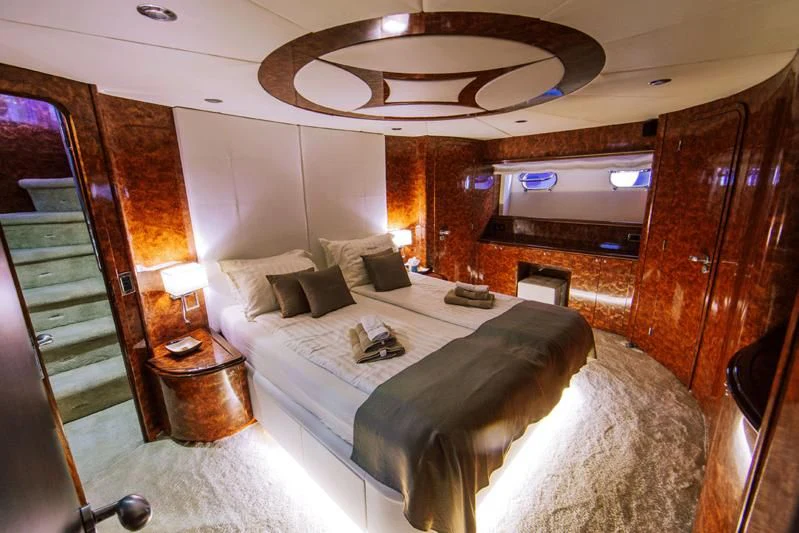 a room with a bed and a table aboard LADY LONA Yacht for Sale