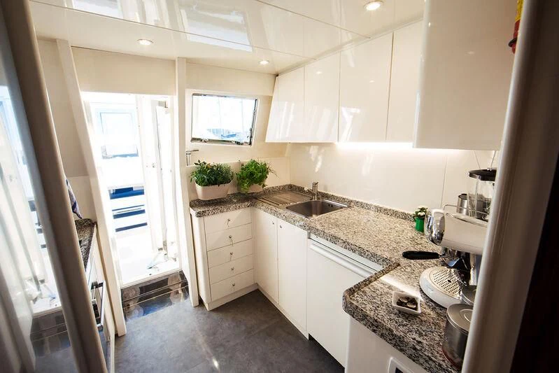 a kitchen with white cabinets aboard LADY LONA Yacht for Sale