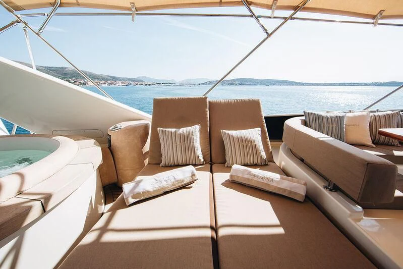 a room with a view of the ocean and a large ship aboard LADY LONA Yacht for Sale