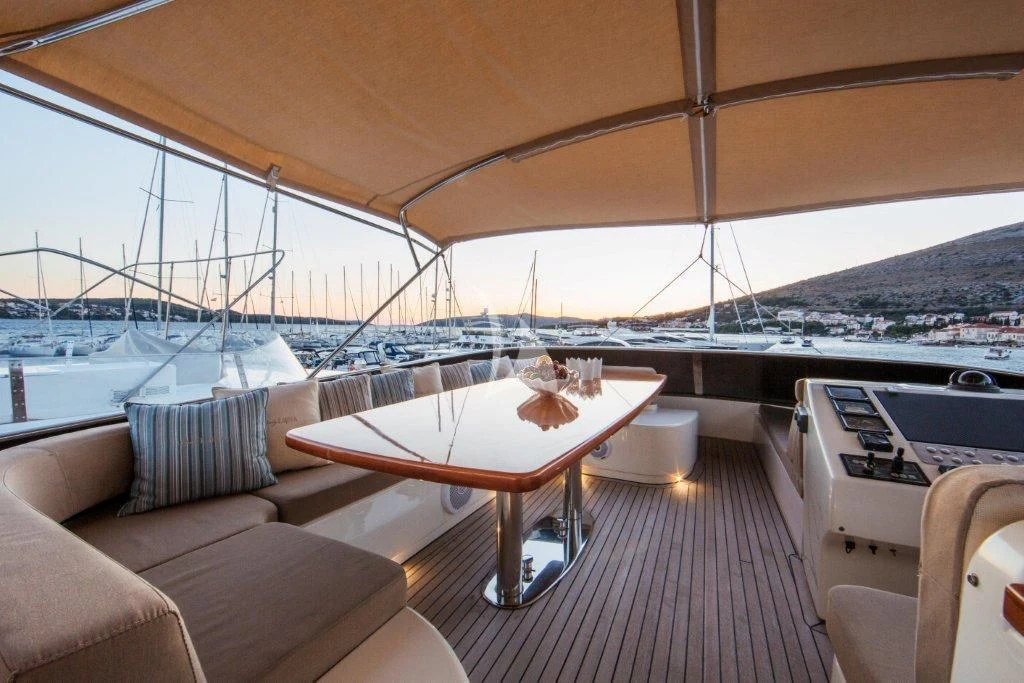 a deck with a table and chairs on it aboard LADY LONA Yacht for Sale