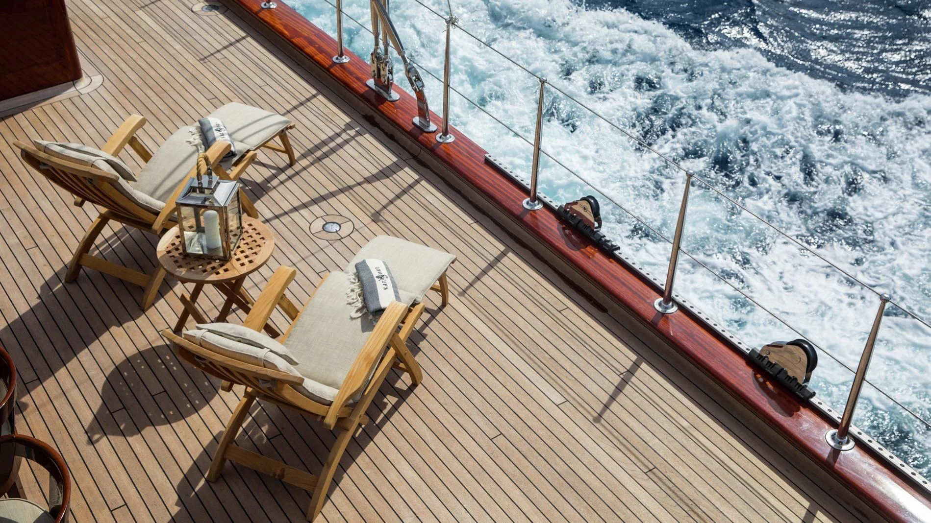 a deck with chairs and a table on it and a view of the earth from a plane aboard NAUTILUS Yacht for Sale
