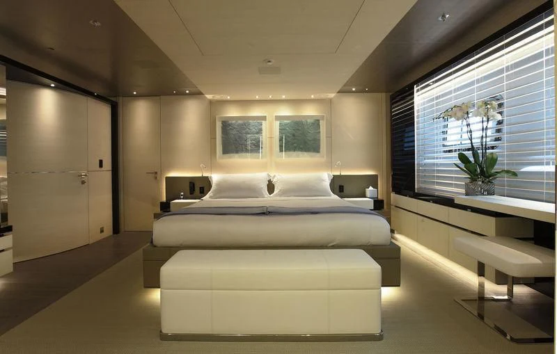 a room with a bed and desk aboard NAUTILUS Yacht for Sale