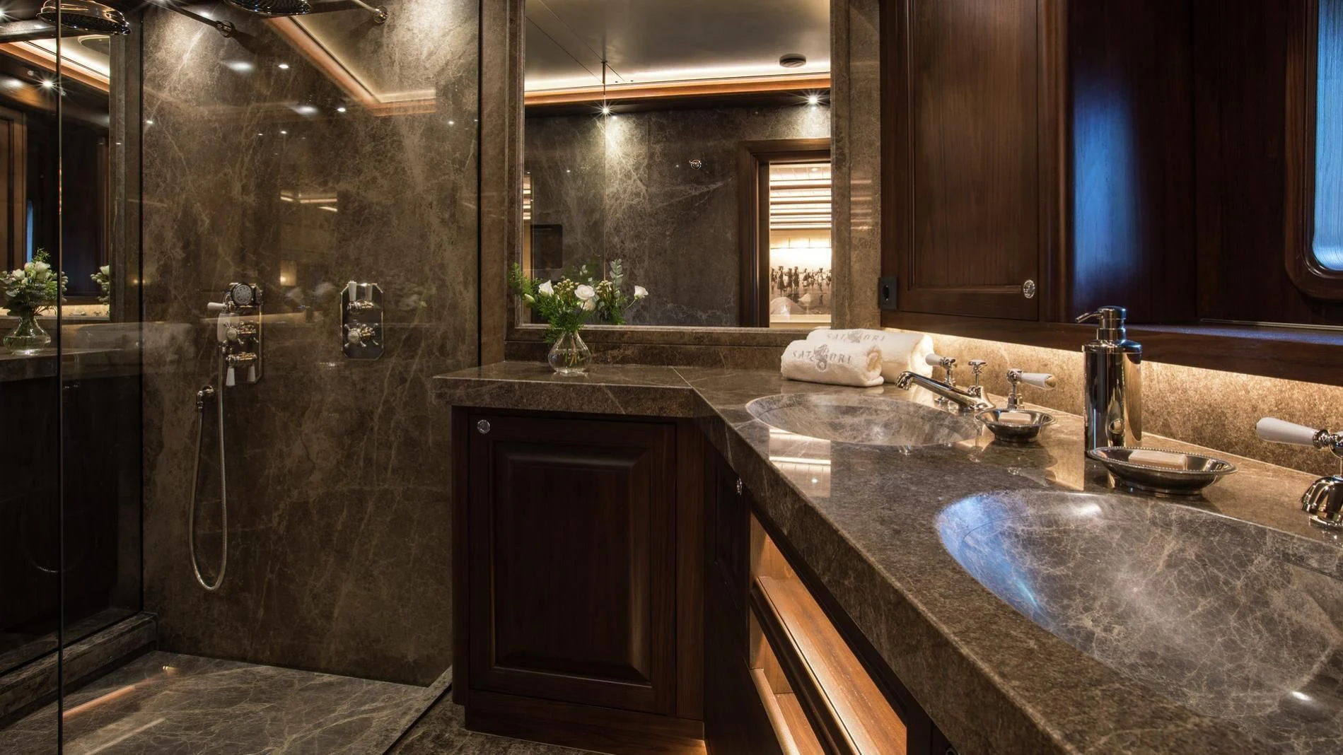 a bathroom with a sink and a large mirror aboard NAUTILUS Yacht for Sale