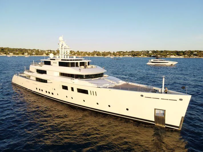 a large white boat on a beach aboard NAUTILUS Yacht for Sale