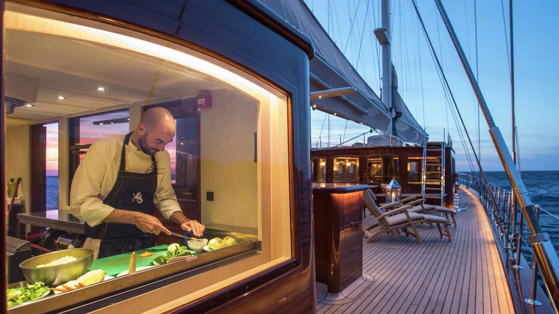 a person cooking food on a boat aboard NAUTILUS Yacht for Sale